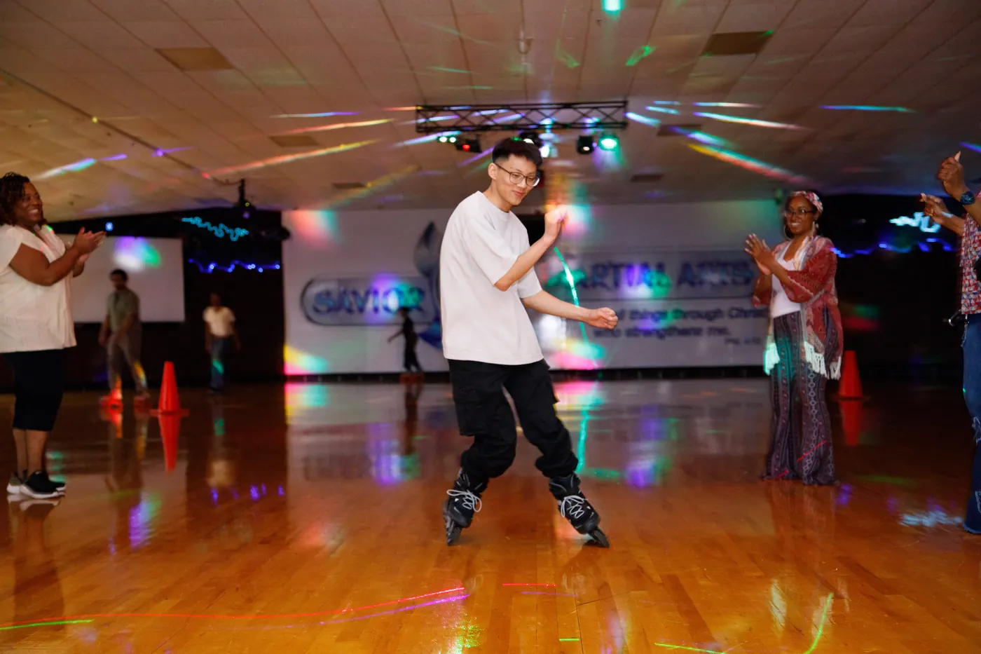 Skater moving through colorful lights at an indoor event