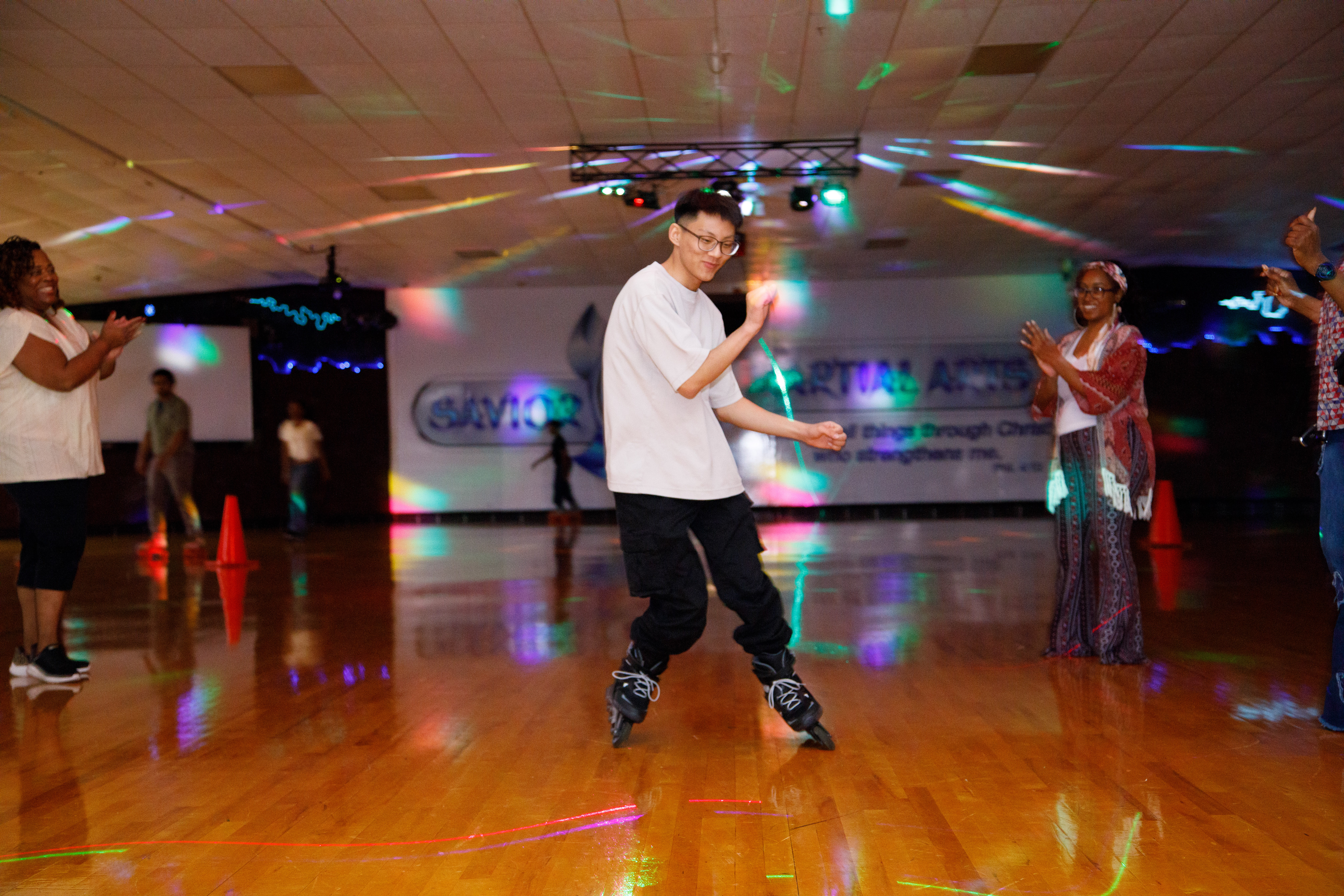 Skater moving through colorful lights at an indoor event