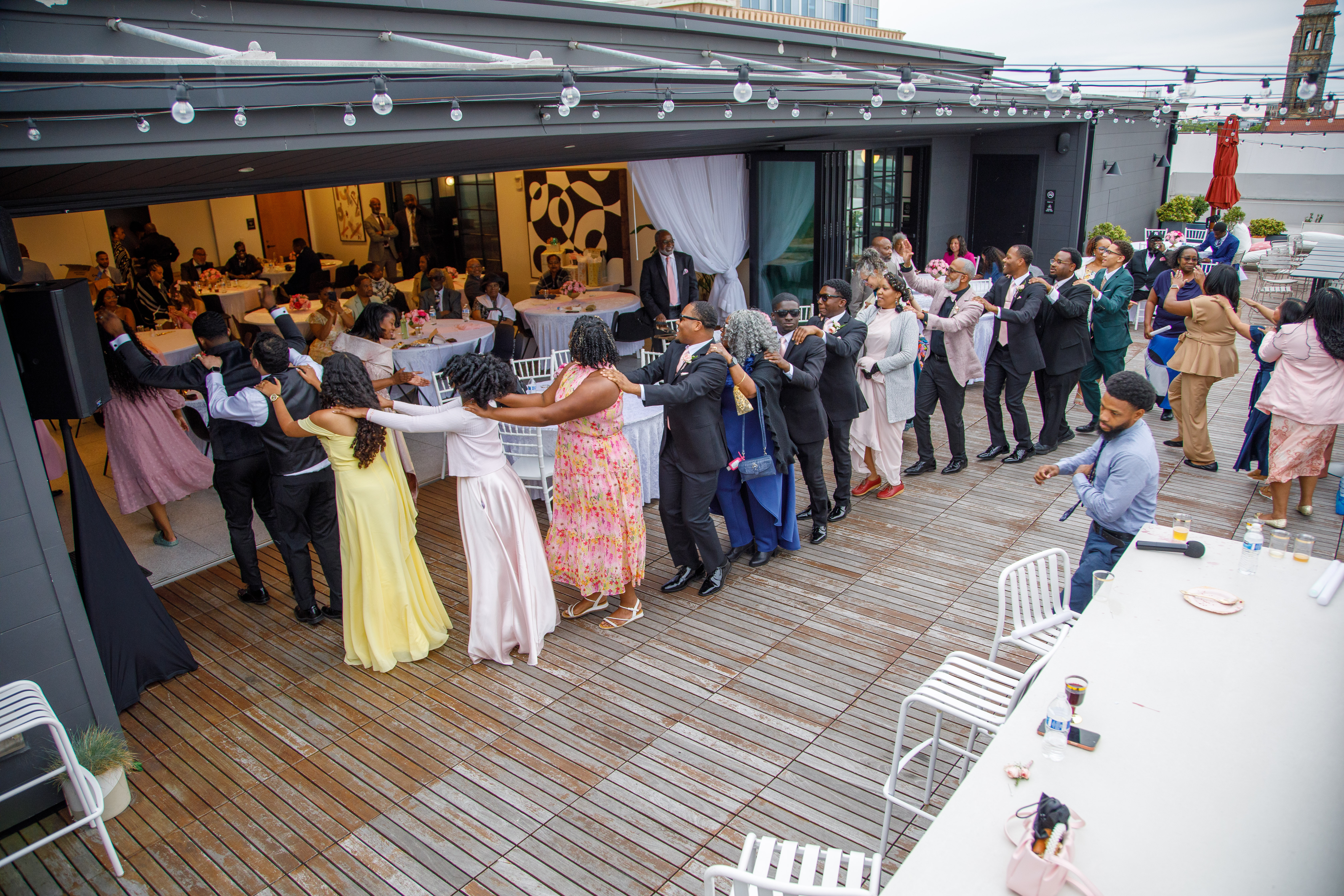 Guests celebrating on a rooftop reception dance floor
